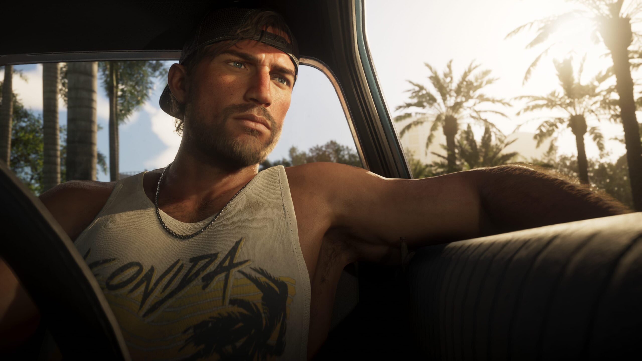 Джейсон із GTA 6 сидить в автомобілі на тлі пальм у Вайс-Сіті — кадр із розширеного трейлера гри